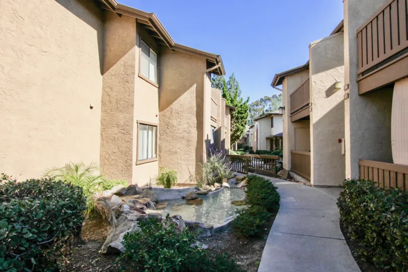 A stone fish poind in the middle of two housing units at Quail Creek in Mira Mesa CA