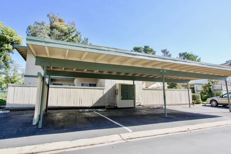 A sunny day in the area of Quest, outside, car port, nehicles, trees, gutter