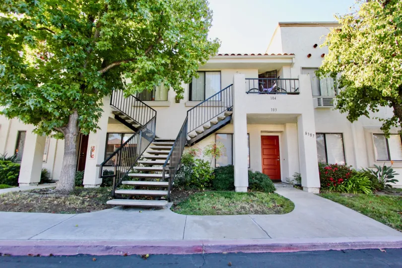 Sunny day trees with front staircase of a residence house in Villas at Capricorn, Mira Mesa, CA