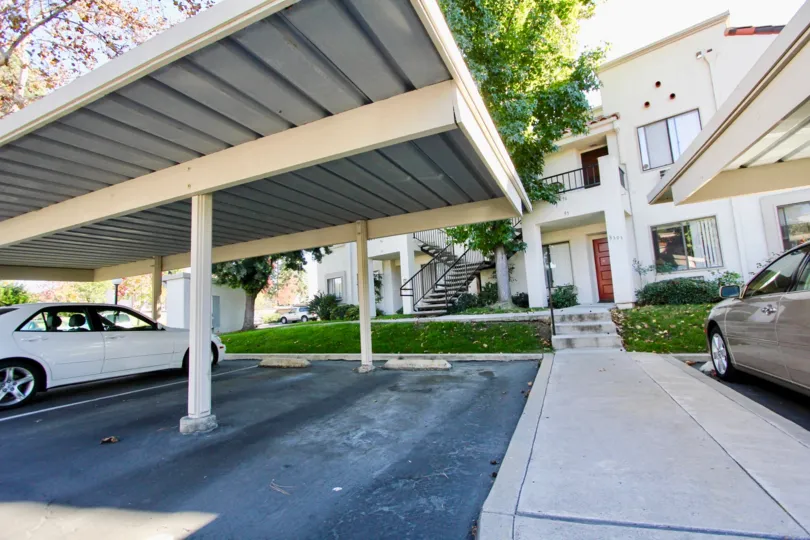 A sunny day in the area of Villas at Capricorn, outside, cars, sidewalk, car port, stairs, condos
