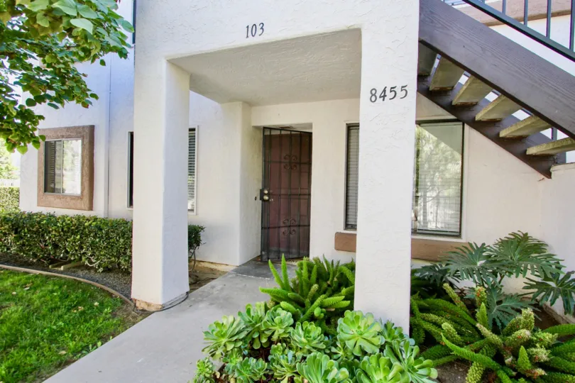 A building with white painting in villas at New Salem, stairs and metal doors provided.