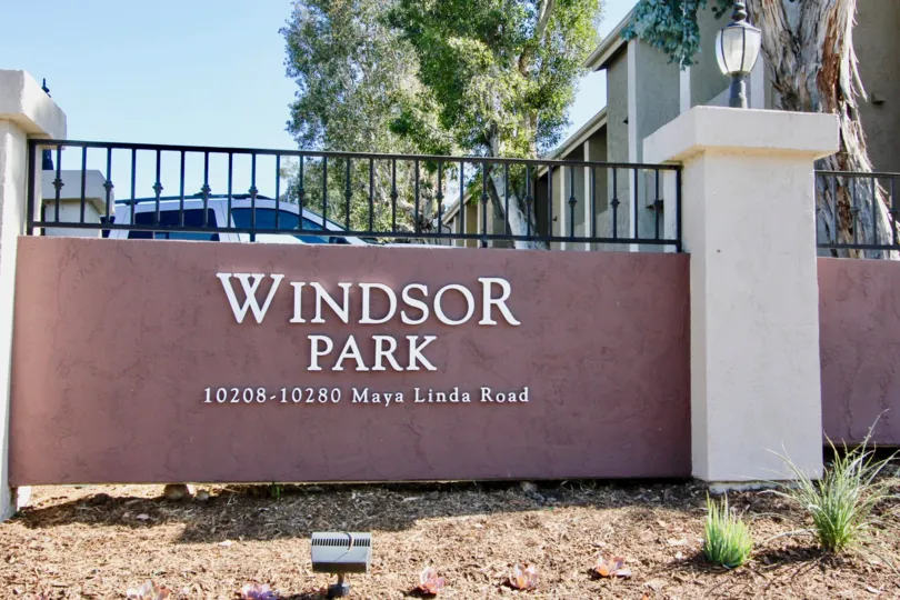 A car parked behind the entrance of Windsor Park in Mira Mesa, California