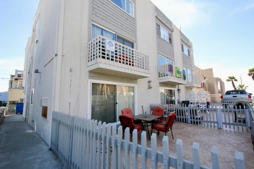 nice sunny day in front of apartment complex on 711 Island court with patio chairs.