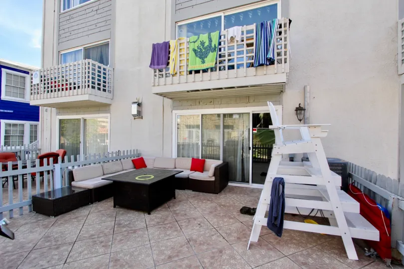 Patio area of apartment building with seating and balconies