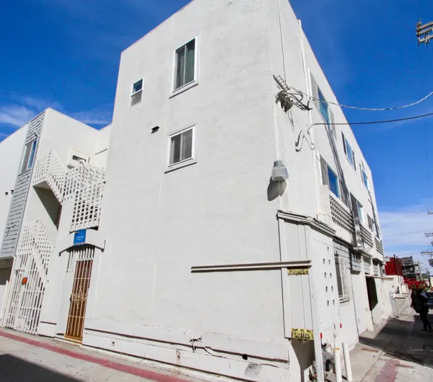 A sunny day showing lady at the white building in 711 Island Court