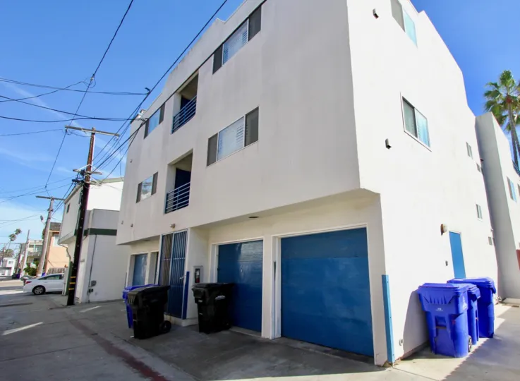 A white apartment with blue trim in Mission Beach, California