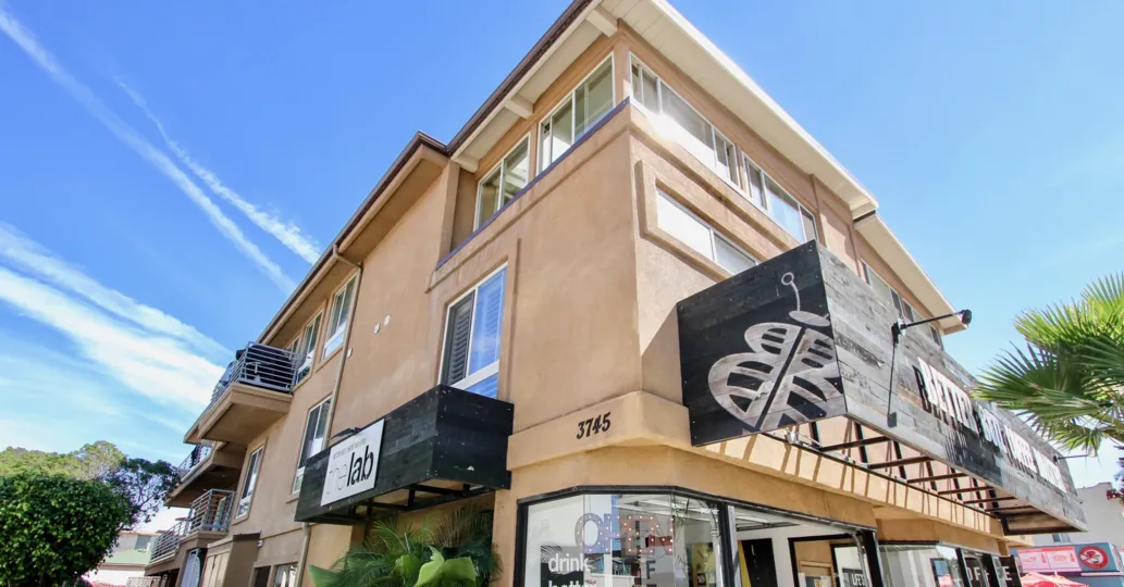 A lovely building sitting on a street corner, showing some of California's famous blue skies