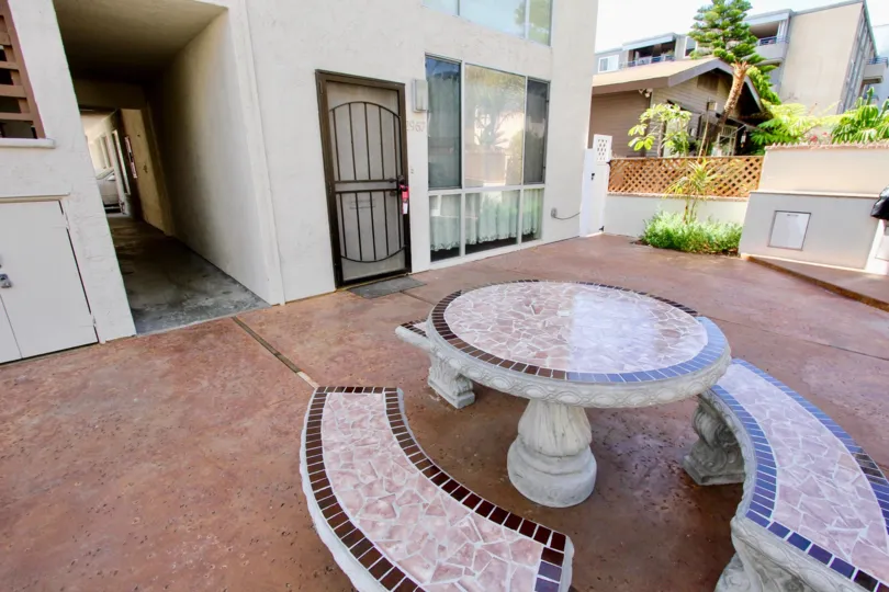 The outdoor paved terrace and seating area outside the Bonita Grande apartment building.