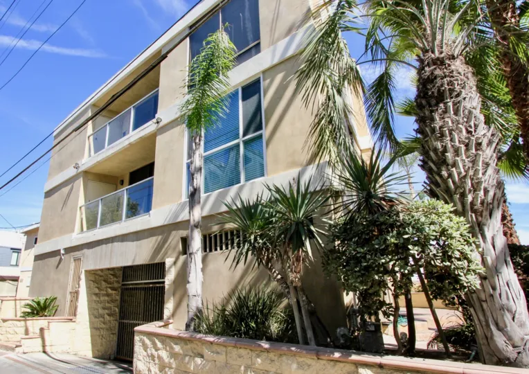 Trees flanking the secured entrance to the Carmel Villas community in Mission Beach, California.