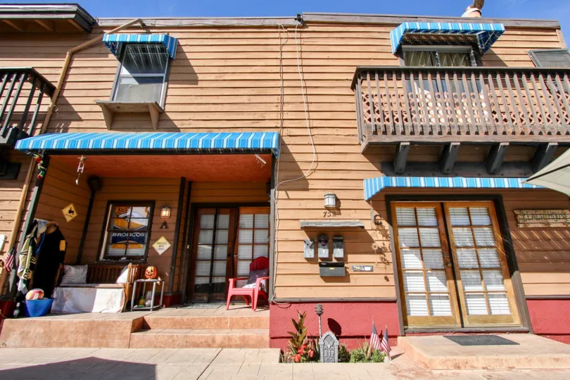 A colorful apartment with blue awnings and red accents in the community of Casa Deal in Mission Beach, CA