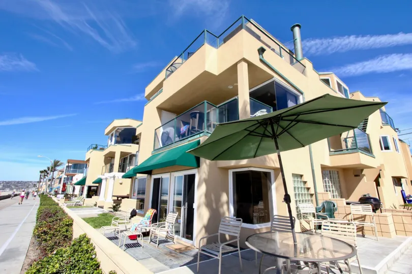 An apartment with patio furniture outside of it on a Sunny Day at Far Horizon in Mission Beach, California