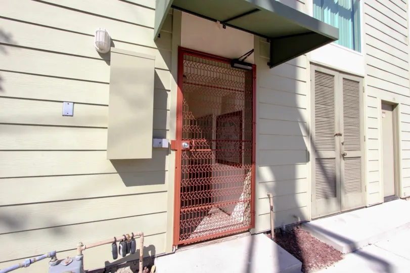Red color entrance gate in front of the building in Franklin Shores