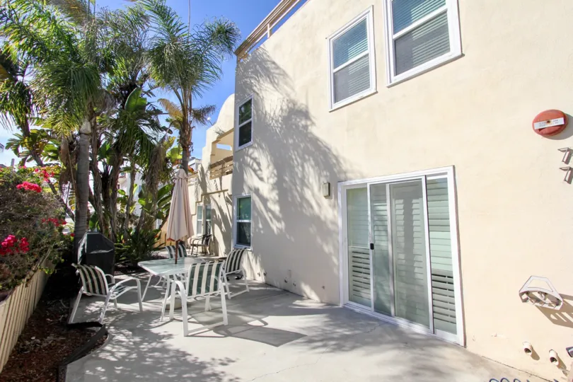 Outside patio with patio table and chairs outside of the Isthmus Condos.