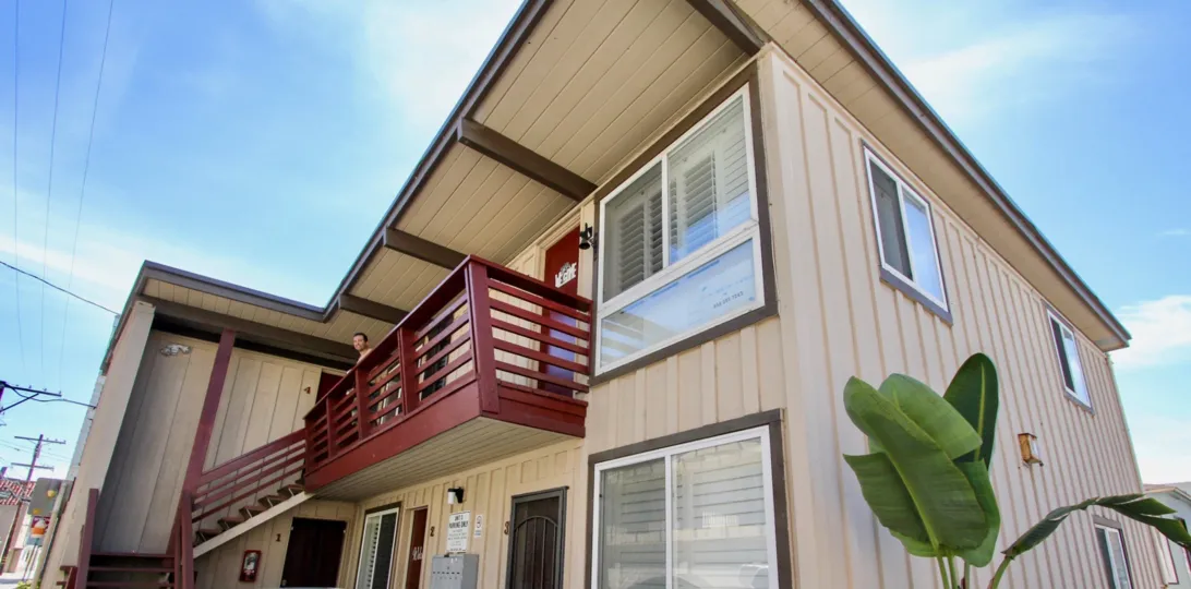 Two story brown condos with a red railing inside Mission Beach Bayside at Mission Beach ca