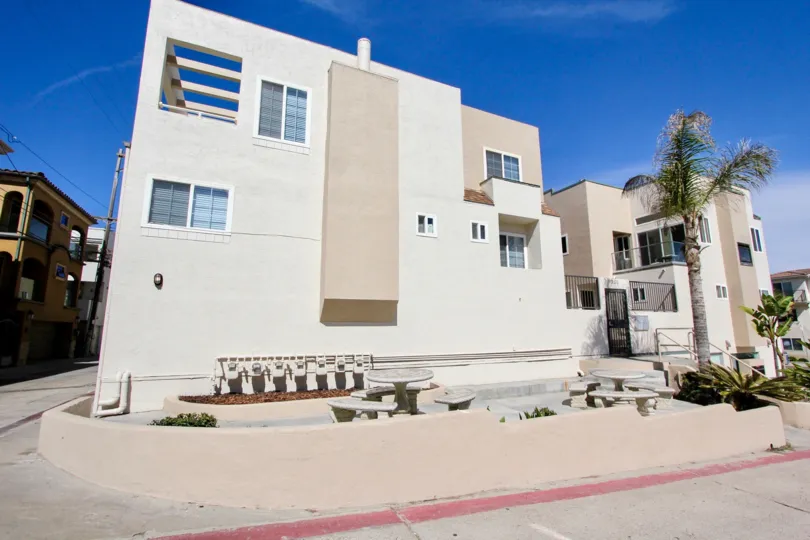 Concrete picnic benches sit in front of Mission Beach Villas