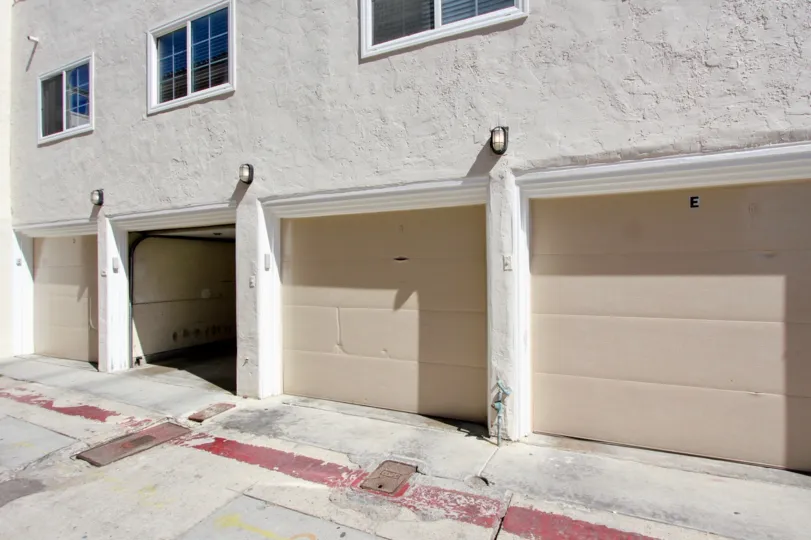 White garages with lights above them at Mission Beach Villas in Mission Beach CA