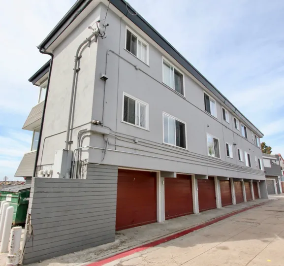 White Two story apartments with parking garages beneath