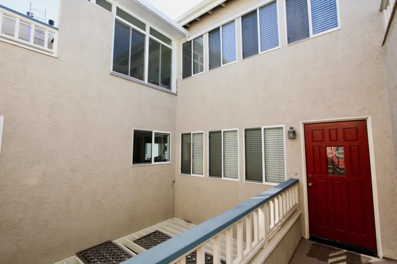 A red doorway and windows in an adobe property at O'Bryan Condos