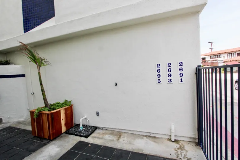 The Side of a white apartment complex apartments 2695, 2693, 2691