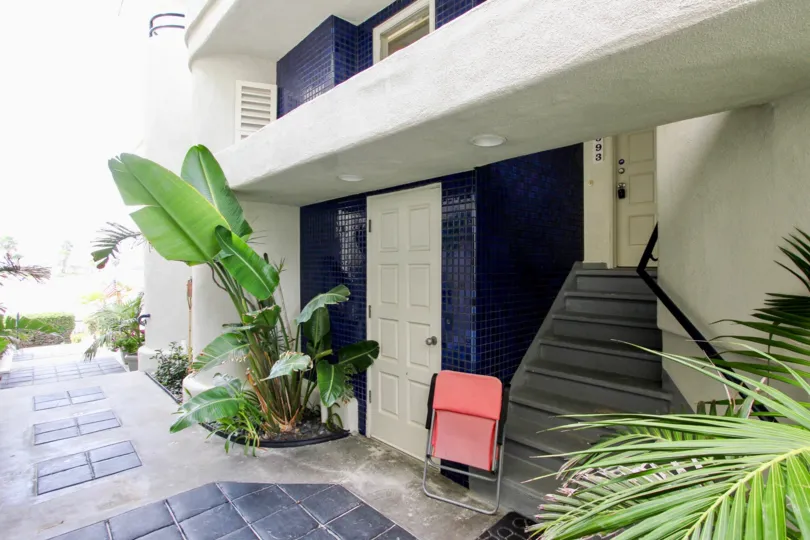 A view of the exterior of the cozy Ocean Vail apartment building with smooth concrete and cobalt blue tiles.