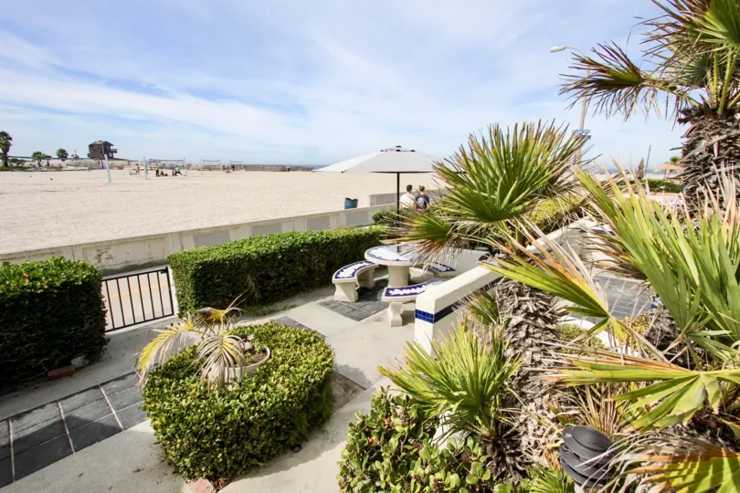 A patio table overlooks a beach at Ocean Vail condos.
