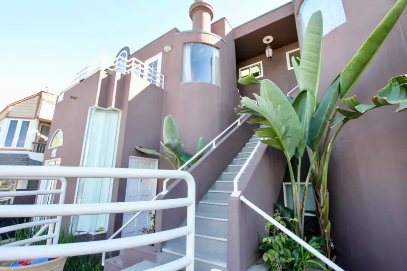 A sunny day in the area of Sand Castle, stairs, condos, plants, windows