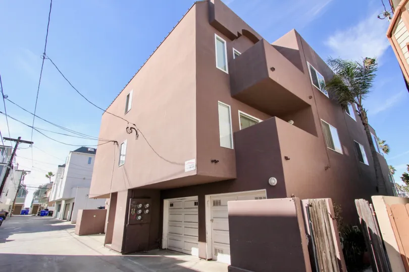 A geometric shaped house with double garage doors in Mission Beach, California
