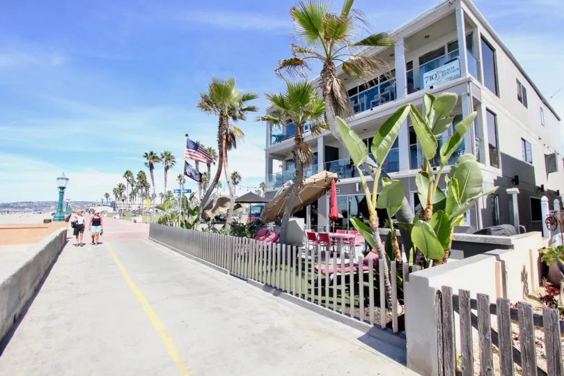 A perfect day in Mission Beach CA with plenty of sun and sand and happy people taking a stroll.
