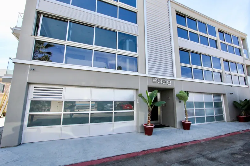 Front view of building on sunny day with plants out front.