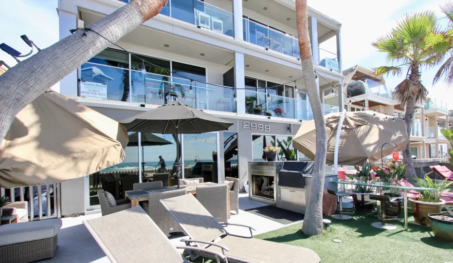 A hotel with beach umbrellas and palms in South Beach neighborhood