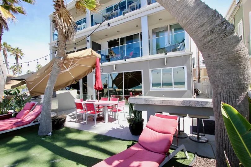 Pink lounge chairs sit on AstroTurf at South Beach condos