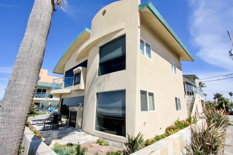 Corner unit with large patio, unique balcony, and plenty of plants at Surf Rider in Mission Beach, California.