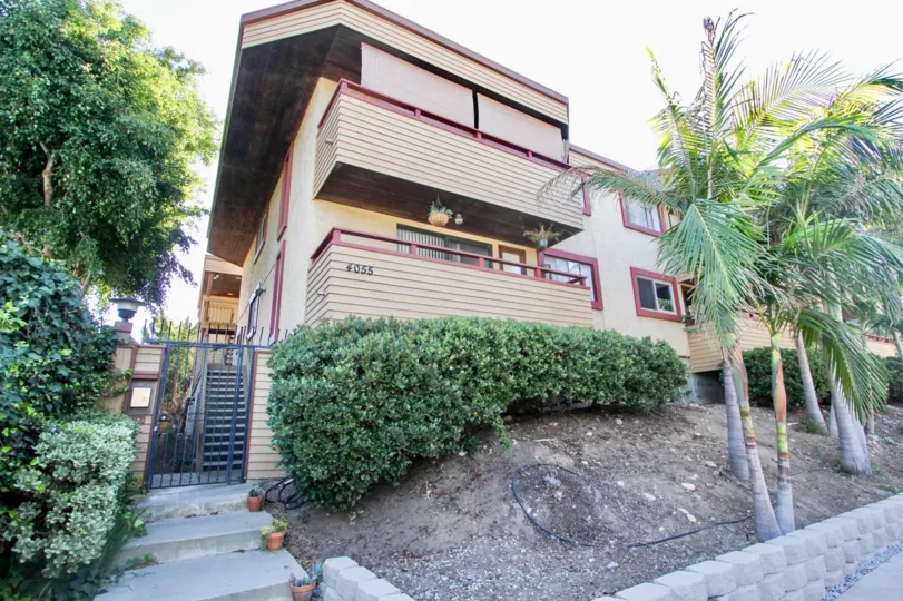 The villa in the 4055 Falcon has plants and bushes at two sides of the house and has flower pots in the door steps