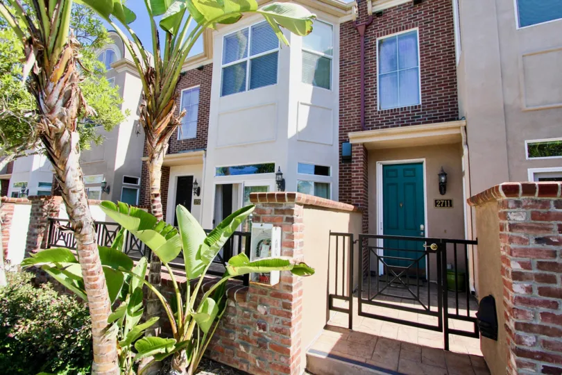 A SUNNY DAY IN THE CAMBRIDGE SQUARE FLAT WITH BANANA TREE, GATE.