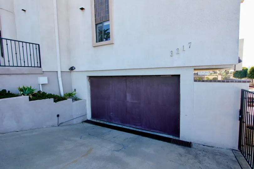 A sunny day in the area of Columbia Heights, garage, fence, plants, window