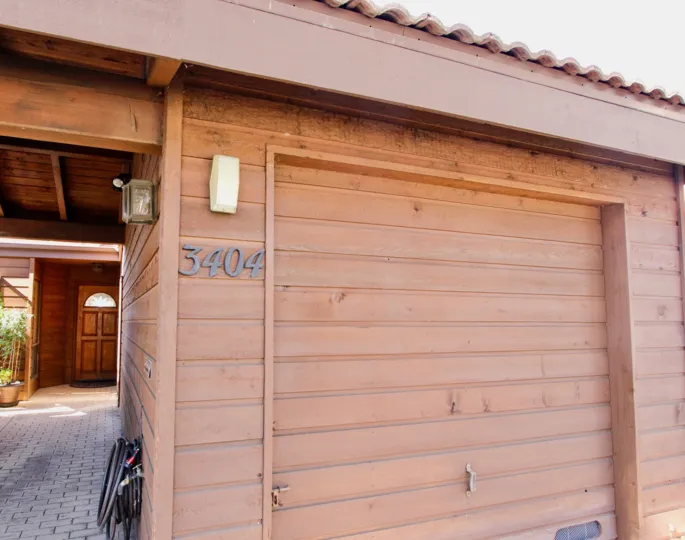 A black water hose is stored on a wall at Columbia Point.