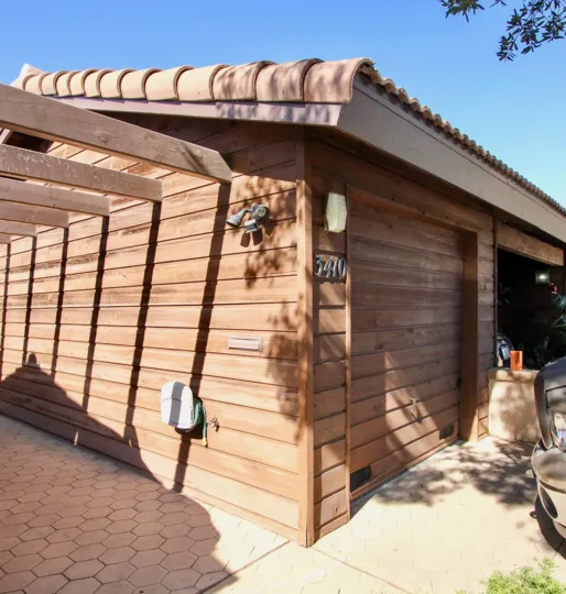 A garage with wooden exterior during a sunny day in Columbia Point, Mission Hills, CA