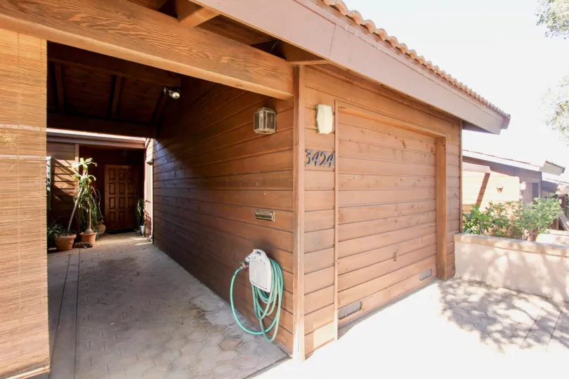View of entrance a house with garage door and walls of wood in the Columbia Point