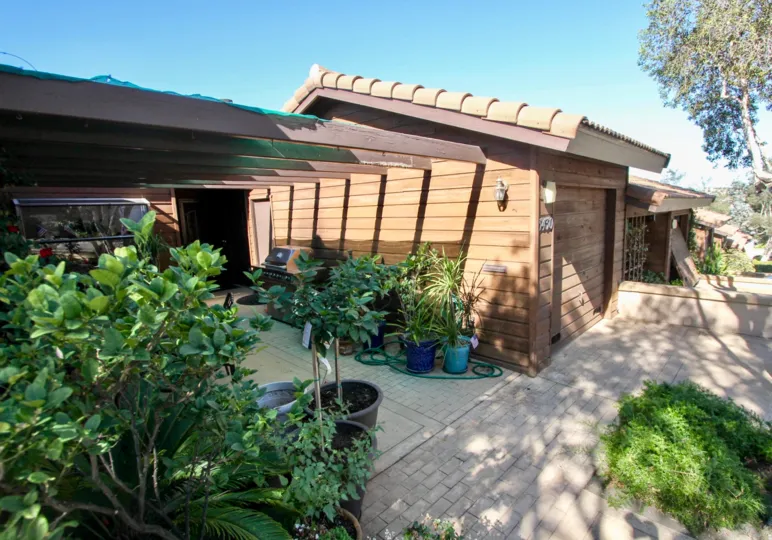 A house in the Columbia Point made up of Woods and has flower pots