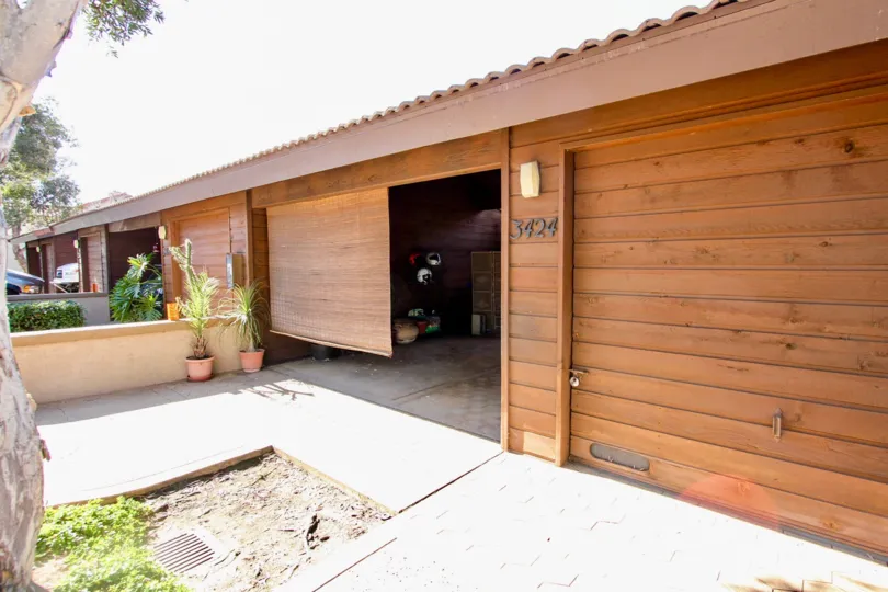 Near the Opened door has two flower pots and covered the room with roof