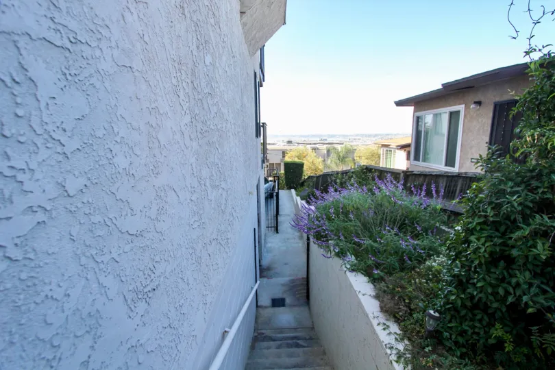 A narrow staircase leads to a patio at Harborview Terrace condos