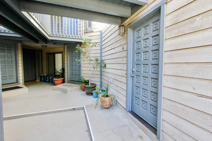 A sunny day in the area of Harborview Terrace, door, plants, condo