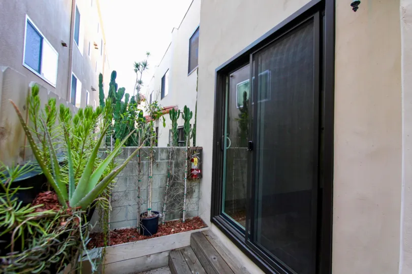 Back side of the door with glass and has flower pots on both sides