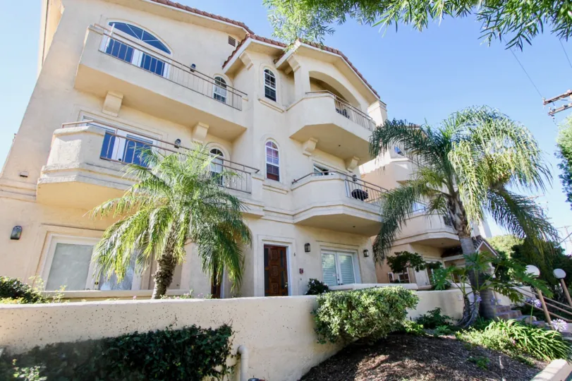 Big apartment complex on a sunny California day with lots of palm trees