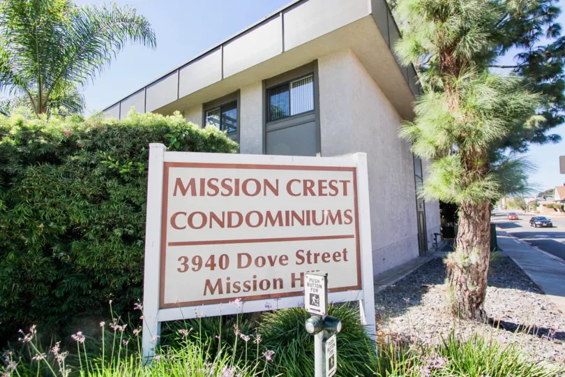 A sunny day in the area of Mission Crest Gardens, fence, palm tree, bush, door, sign