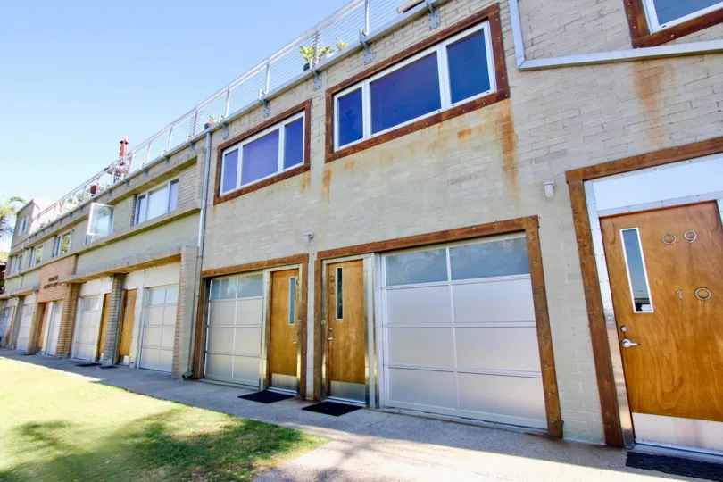 Stylish designed wooden door entrance with glass windows in Moddom. Aluminium entrance welcomes Moddom Homes, Mission Hills, CA.