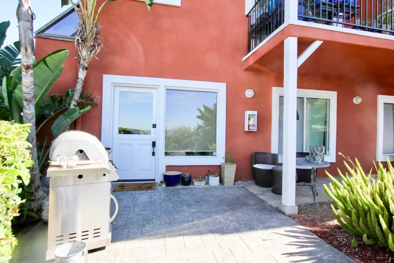 Back patio and entrance view at South Mission Hills Condos Side alley view at 3922 Albatross in Mission Hills, CA