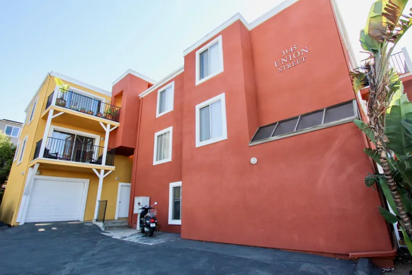 The house painted with yellow has flower pots in balcony of South Mission Hills Condos