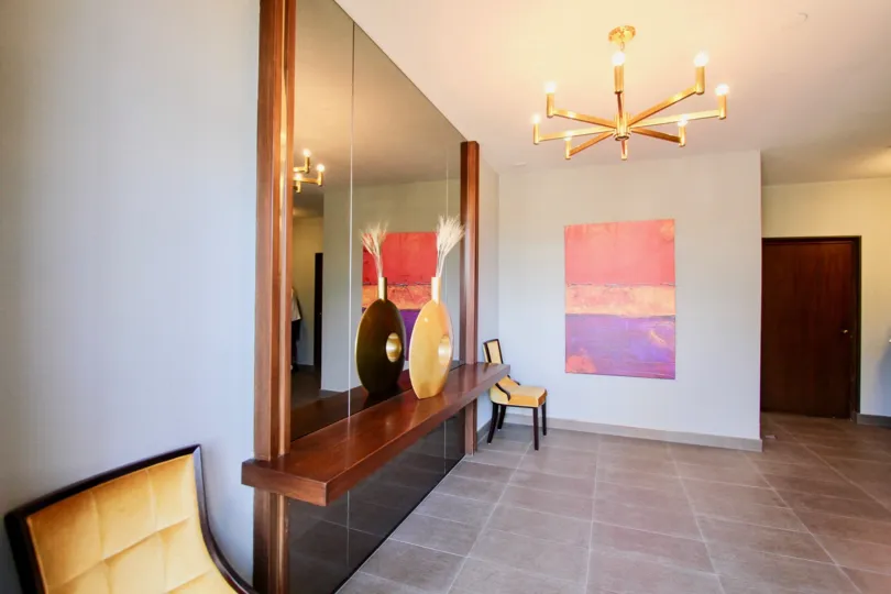 Interior living room, mirror and decorations at Sprucewood Back patio and porch in Redwood Condominiums in Mission Hills, CA