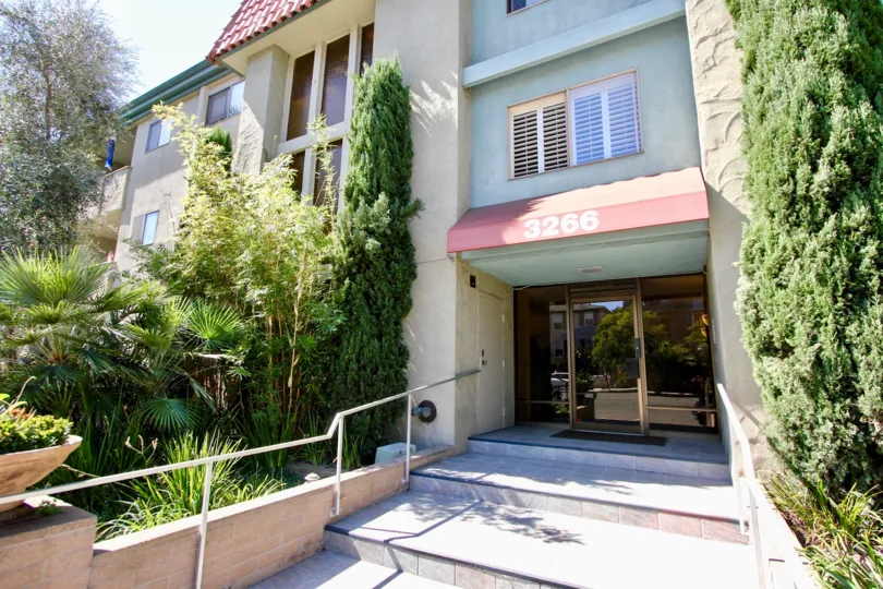 Elevation view with glass door entrance and garden of The Capistrano.